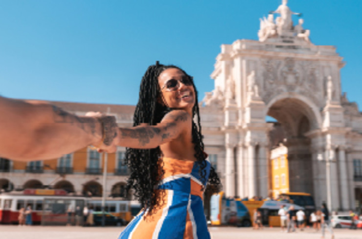 man and lady holding hands outside building in lisbon
