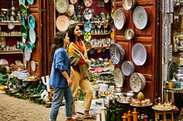 two ladies looking at plates in marrakesh
