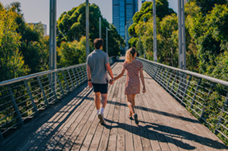 couple walking across bridge in melbourne