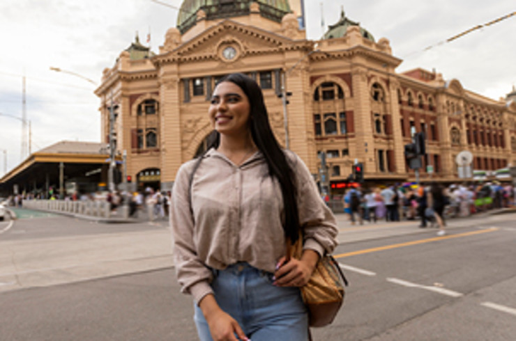 Lady standing in front of Flinders Street Railway Station