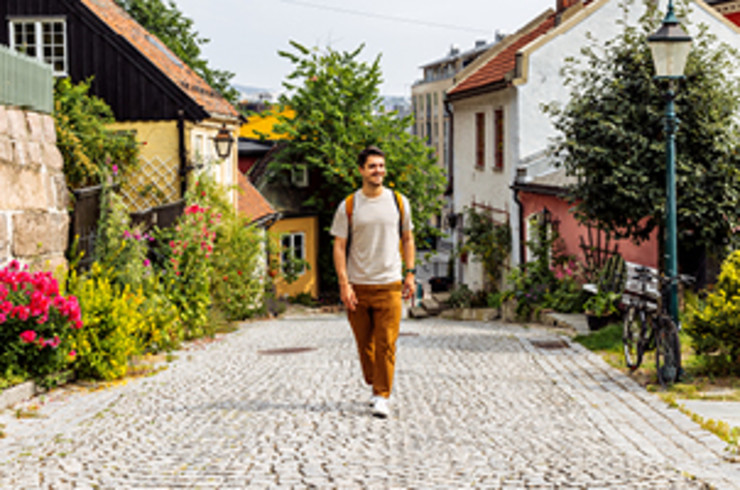 man walking up street in oslo
