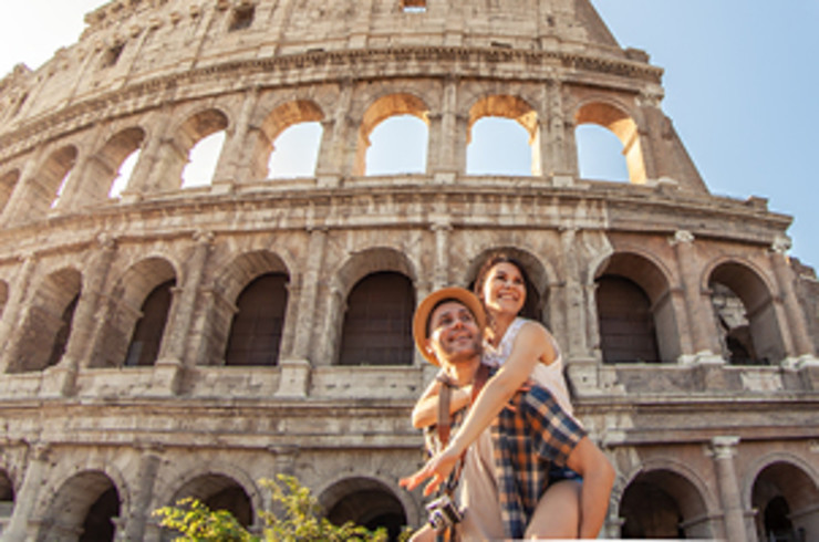 Two people in front of the Colosseum