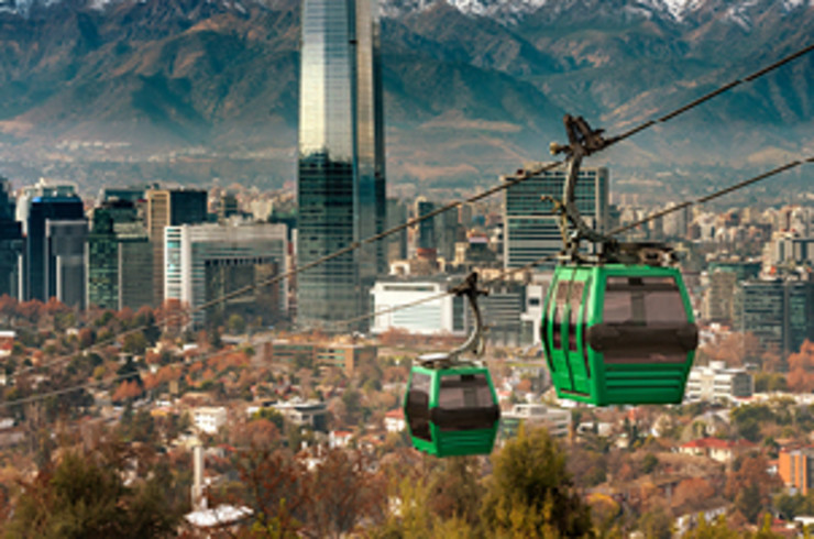 Photo of Santiago Airport, and the cable cars in the foreground are part of the city’s distinctive urban transport system. 