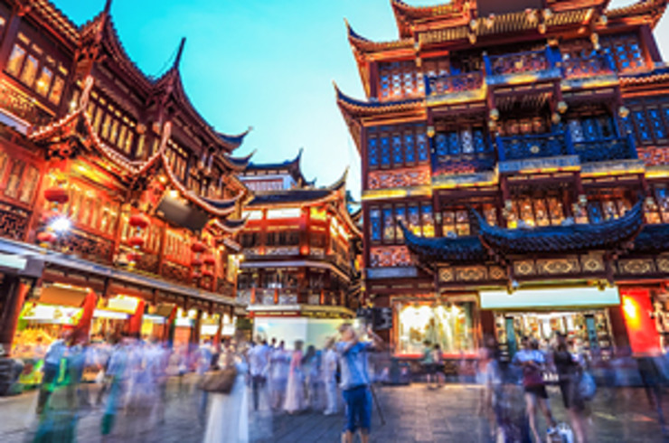 buildings in shanghai with people moving on streets below