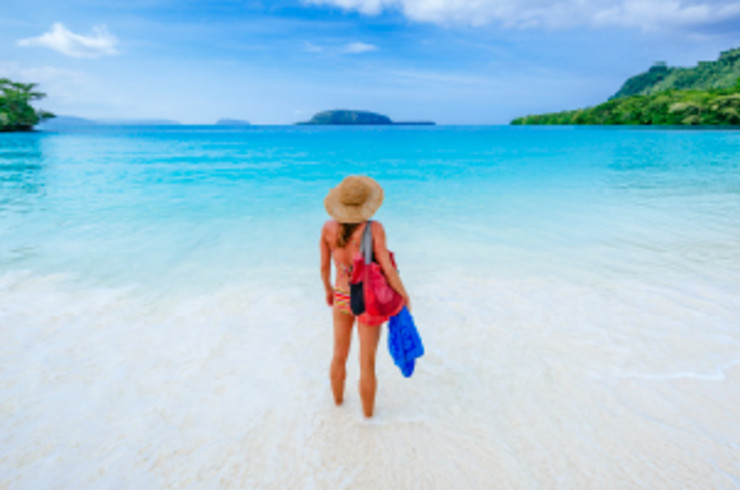 Lady at Champagne Beach looking out at clear water