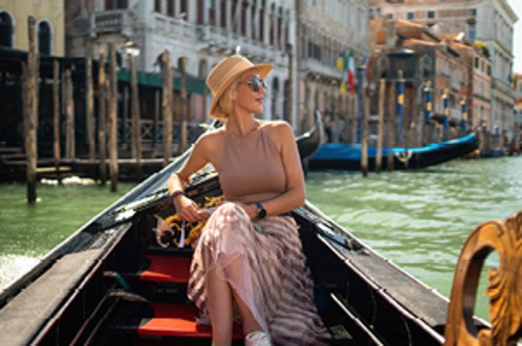 lady sitting on gondola on venice canal