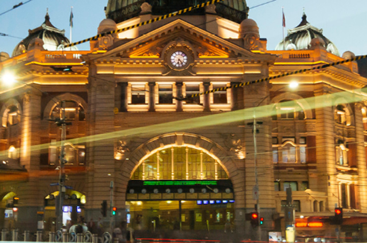 melbourne train station at night lit up 