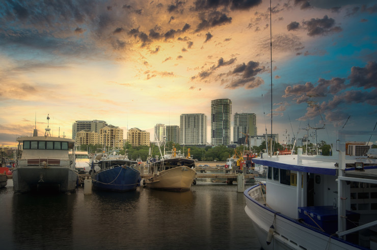 Catamaran fishing boats in front of Darwin city at sunset