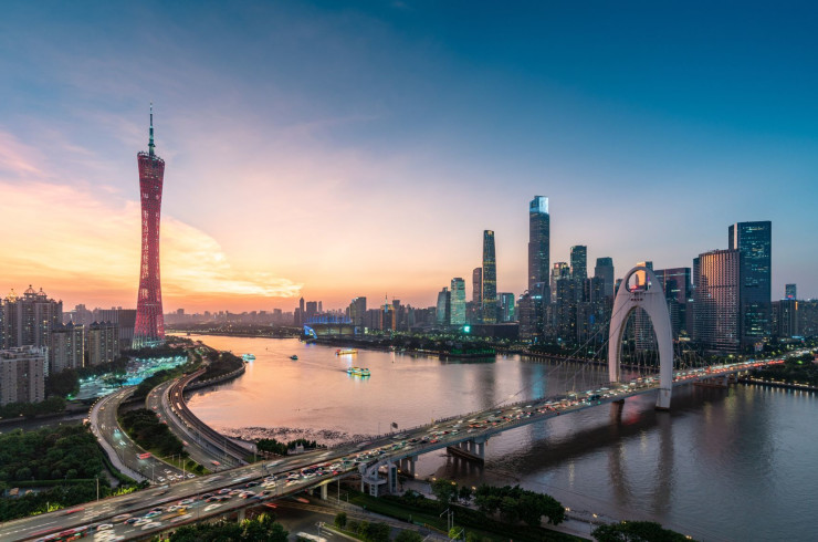 City skyline of Guangzhou at sunset, featuring Liede Bridge and Canton Tower