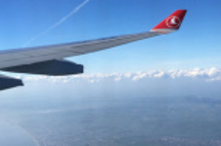 A view of a Turkish Airline aircraft's wing while flying during a popular international flight route.