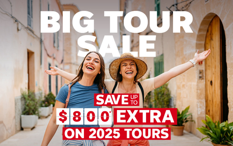 Big Tour Sale | Save up to $800* extra on 2025 tours | Two girls cheering walking past sandstone buildings