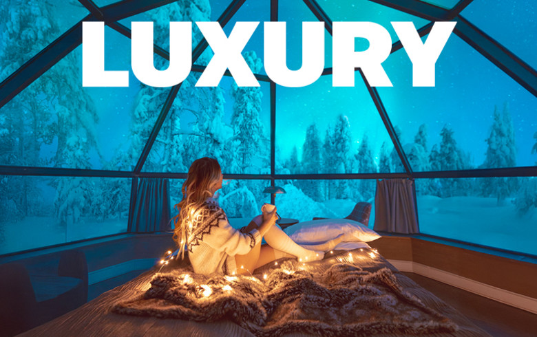 Luxury - woman relaxing in a glass igloo