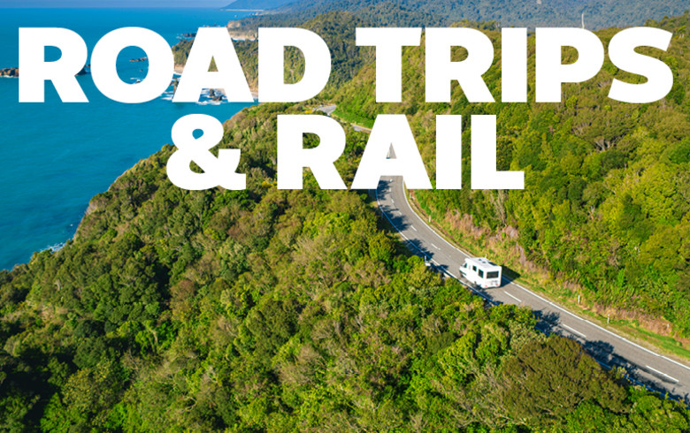 Road Trips & Rail - wideshot of a motorhome driving through a forest near the coast