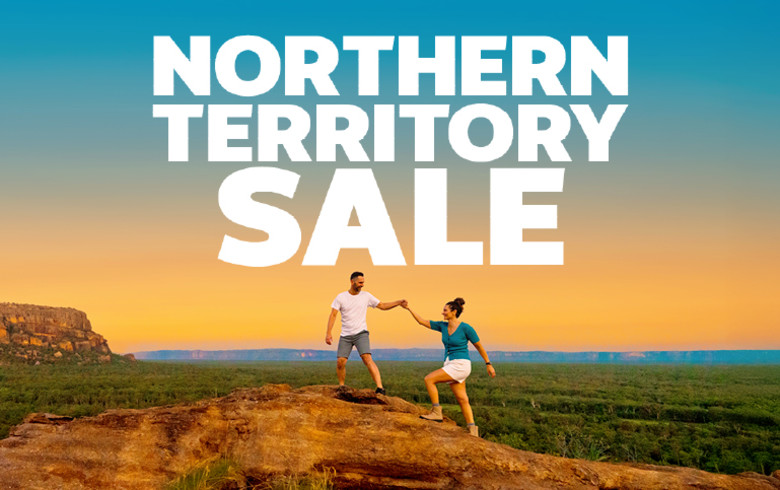 Northern Territory Sale - couple holding hands on a rock overlooking the Australian outback