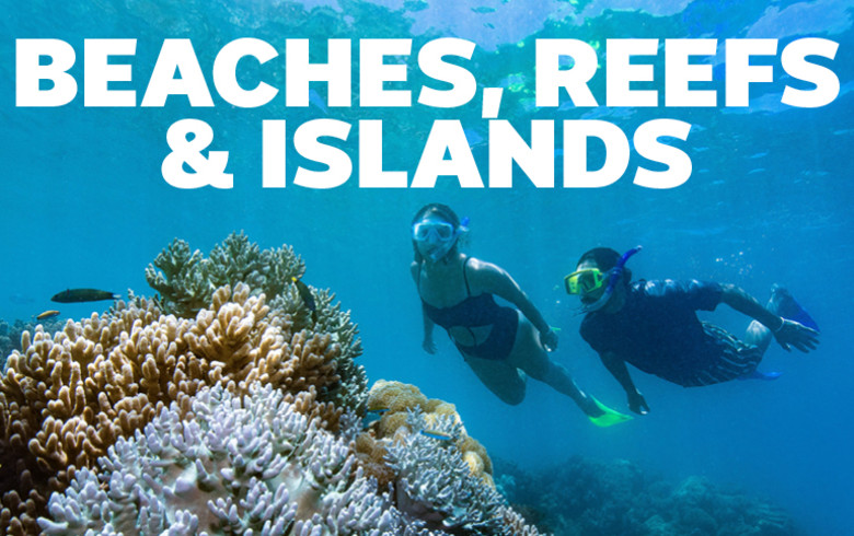 Beaches, Reefs & Islands | two people snorkelling, looking at a coral reef