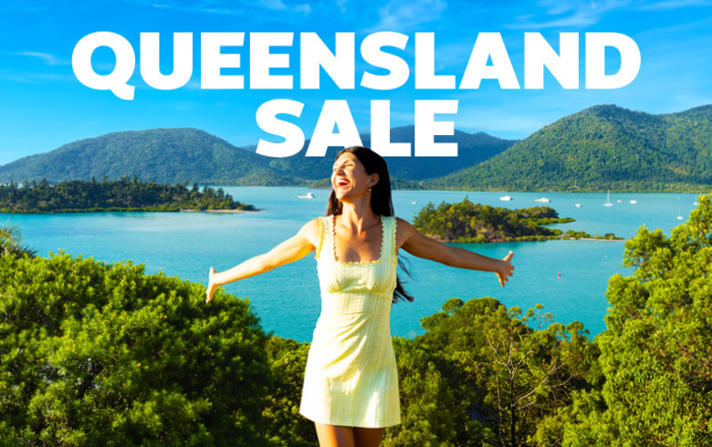 Queensland sale - woman laughing with her hands outstretched, with islands in the background