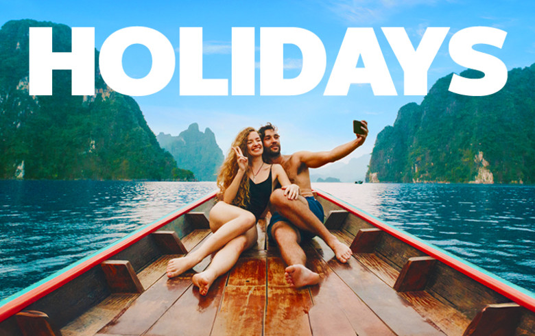 Couple taking a selfie on a wooden boat