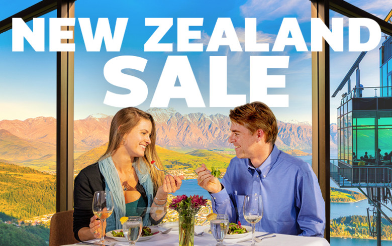 Couple sharing a fancy lunch from the Star gazing lookout in Queenstown New Zealand on a sunny day