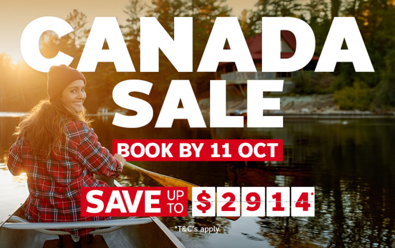Woman wearing a red plaid shirt rowing on a lake at sunset featuring a Canada sale with savings up to $2,914
