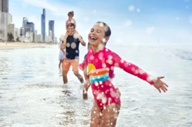 Child splashing in the water at the beach