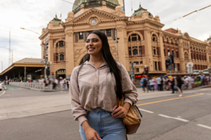 Lady standing in front of Flinders Street Railway Station