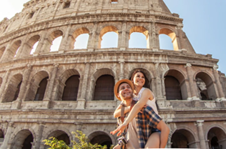Two people in front of the Colosseum
