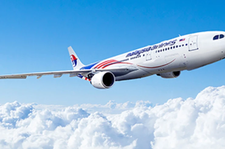 Malaysia Airlines plane flying through clouds