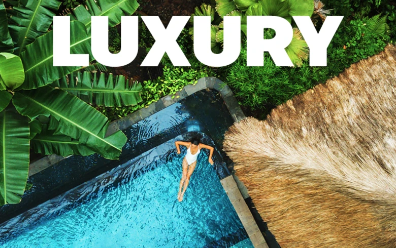 Luxury - top down view of a woman relaxing in an L-shaped pool