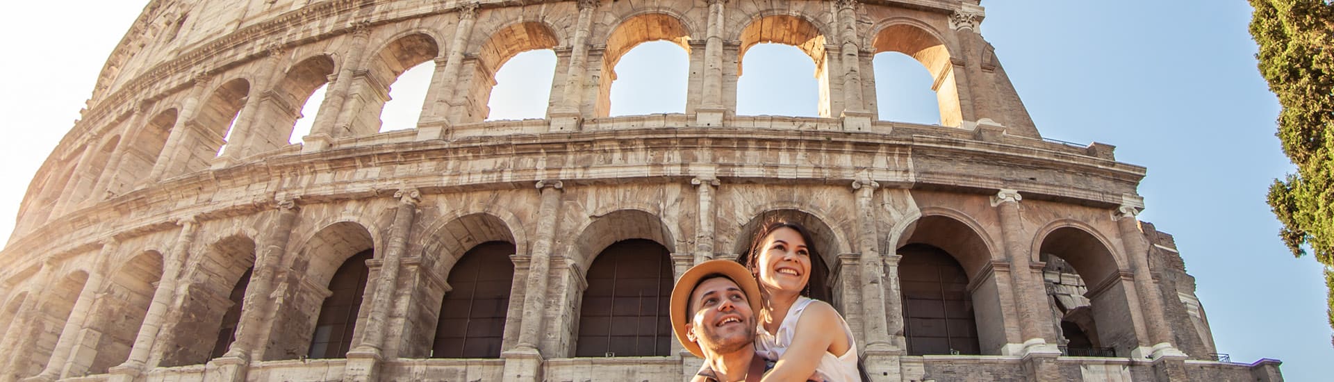 A couple in front of the Coliseum in Rome