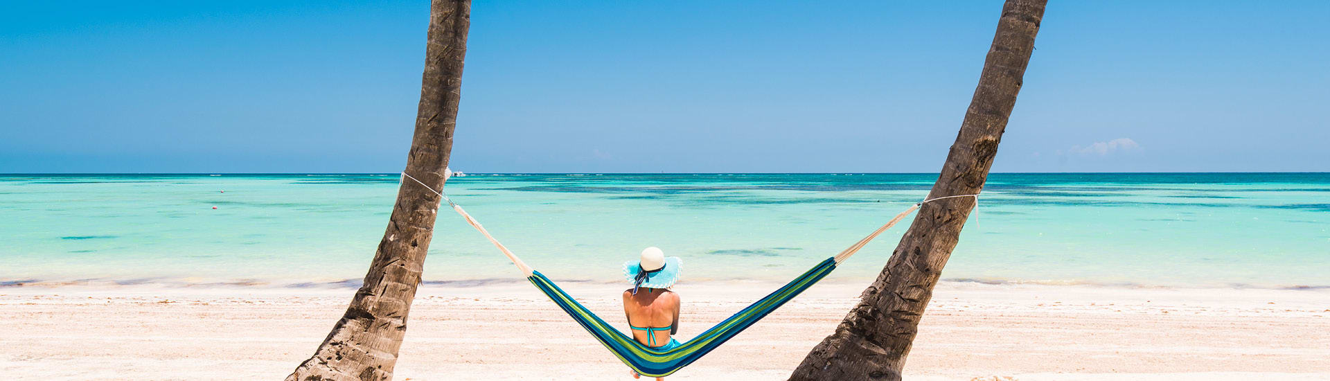 A woman on a hammock on the beach