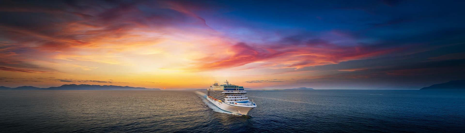 A cruise ship sailing at sunset