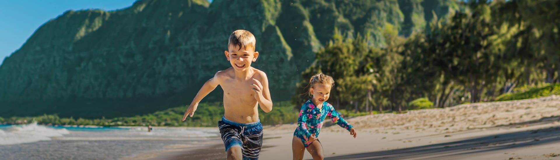 kids running on tropical beach
