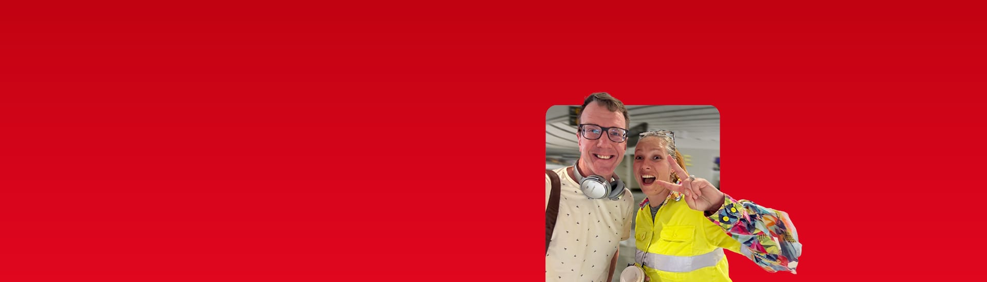 Two business travellers smiling at an airport