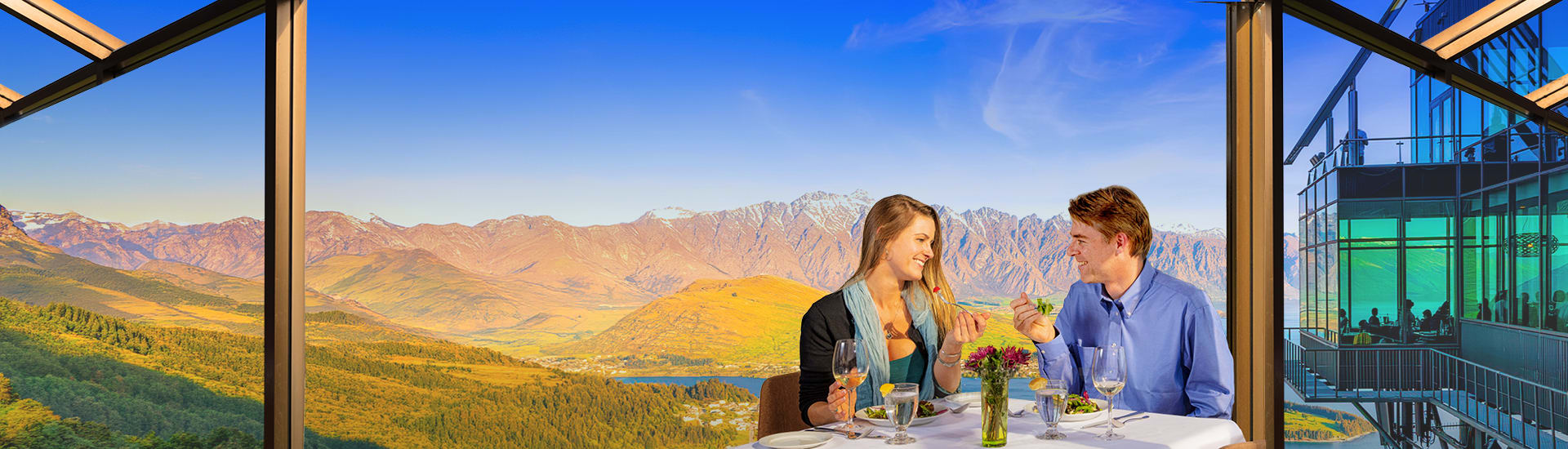 Couple sharing a fancy lunch from the Star gazing lookout in Queenstown New Zealand on a sunny day
