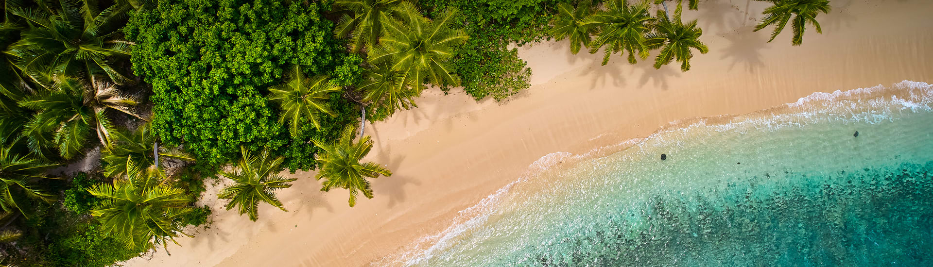 Aerial view of turquoise waves meeting a palm-lined beach for a 7-night Sofitel Fiji escape with up to $1000 bonus value 4 night mooloolaba holiday up to $1000 bonus value