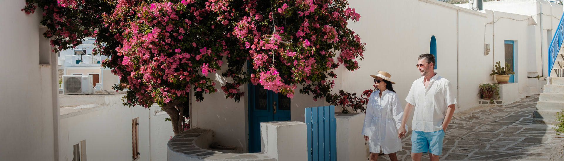 Couple walking through Greece town
