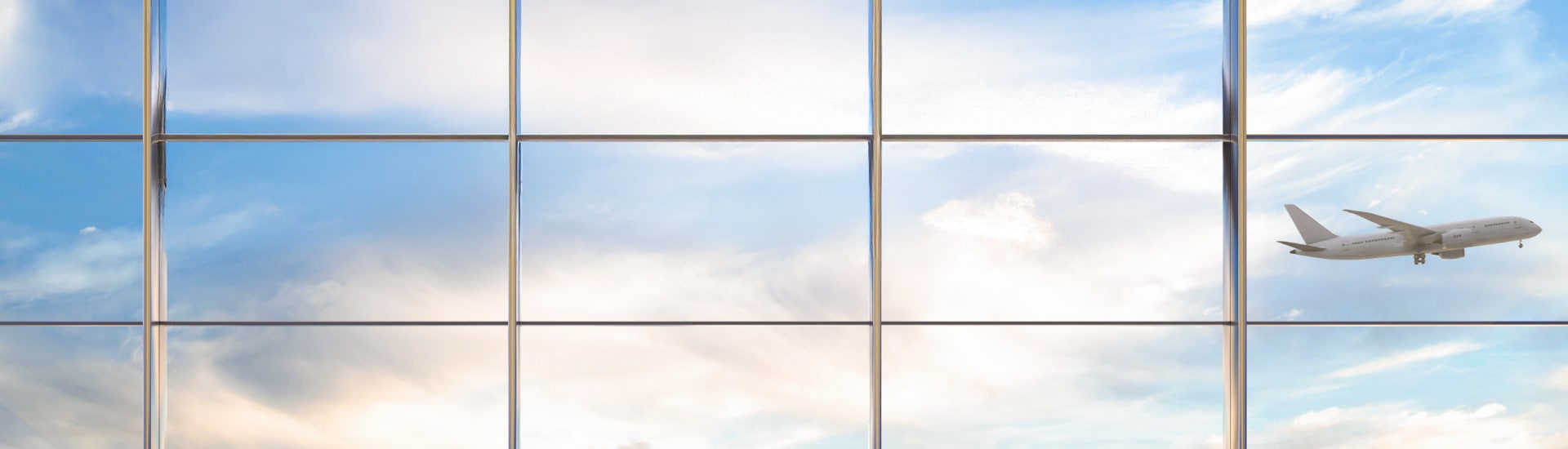 Plane flying past airport window