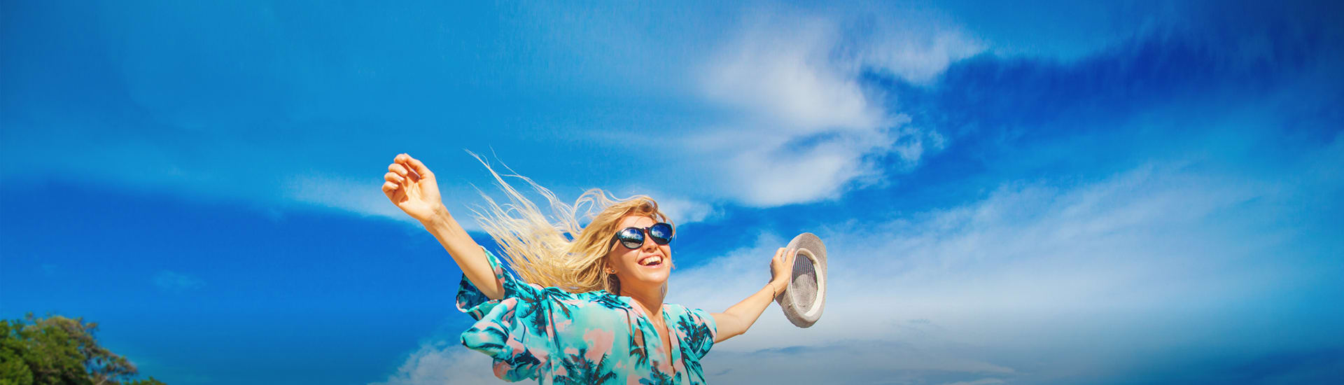 A woman smiling and enjoying a blue sky day