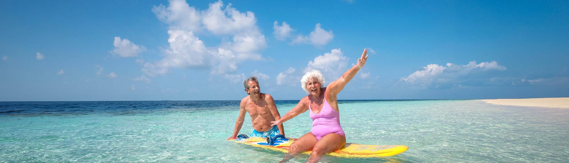A couple on a paddle board at the beach