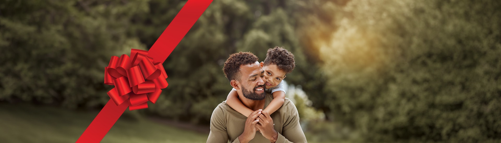 Child embracing his father from behind while both smile warmly