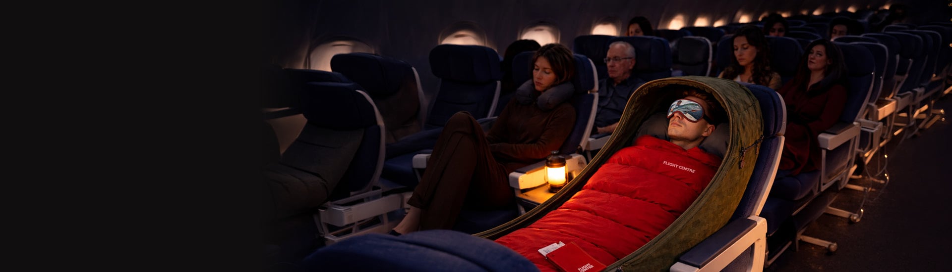 Man relaxing in a sleeping bag on an airplane