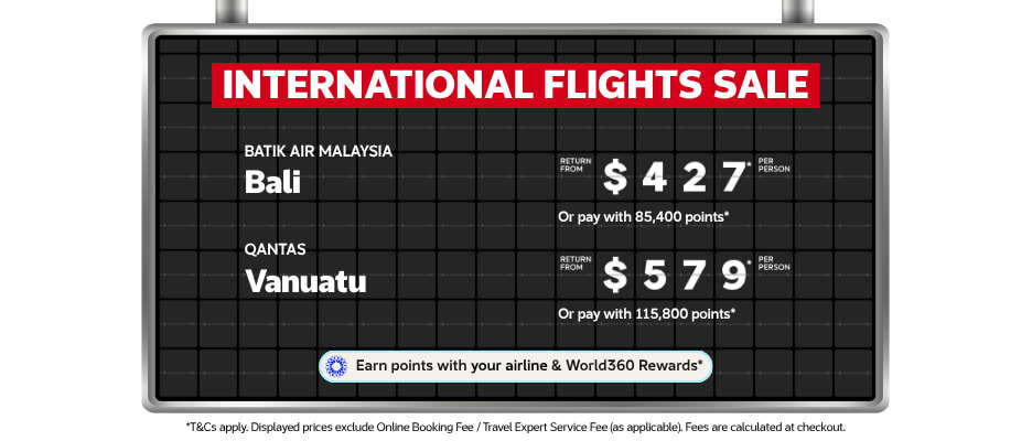 Black airport departure board announcing the International Flights Sale with return flights to Bali from $427 and Vanuatu from $579 per person