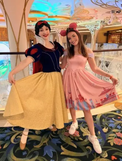 Abby Pezze meeting the Snow White character in a themed dress aboard the Disney Adventure.