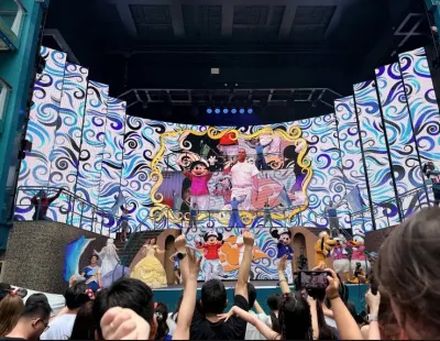 Disney characters performing a live stage show to a crowd aboard the Disney Adventure.