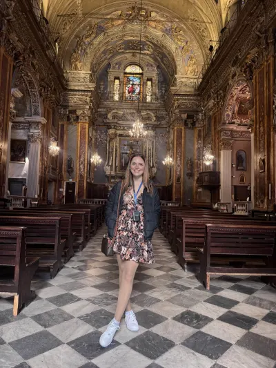 Abby Pezze inside an ornate Baroque church on the French Riviera during a guided visit. 