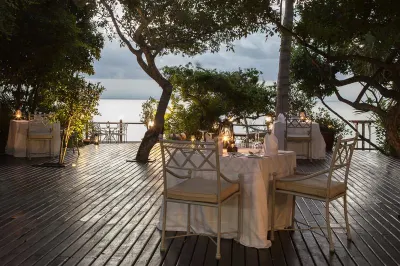Dining table set up on deck in tropical location