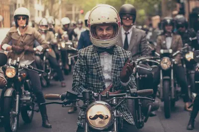 Men in old fashioned dress on motorbikes