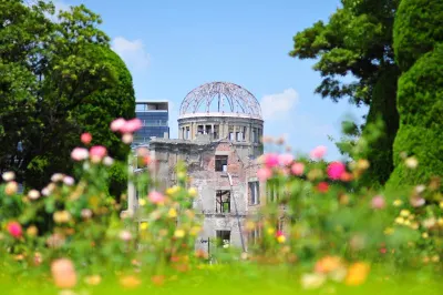 The ruins of the Genbaku Dome in Hiroshima, with flowers in foreground