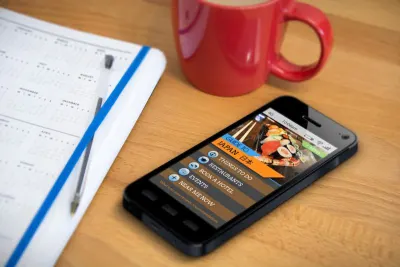 Phone on table with Japan travel app open