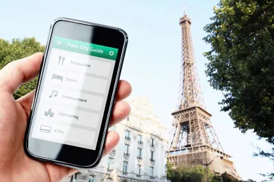 Phone screen with Paris city guide against Eiffel Tower backdrop